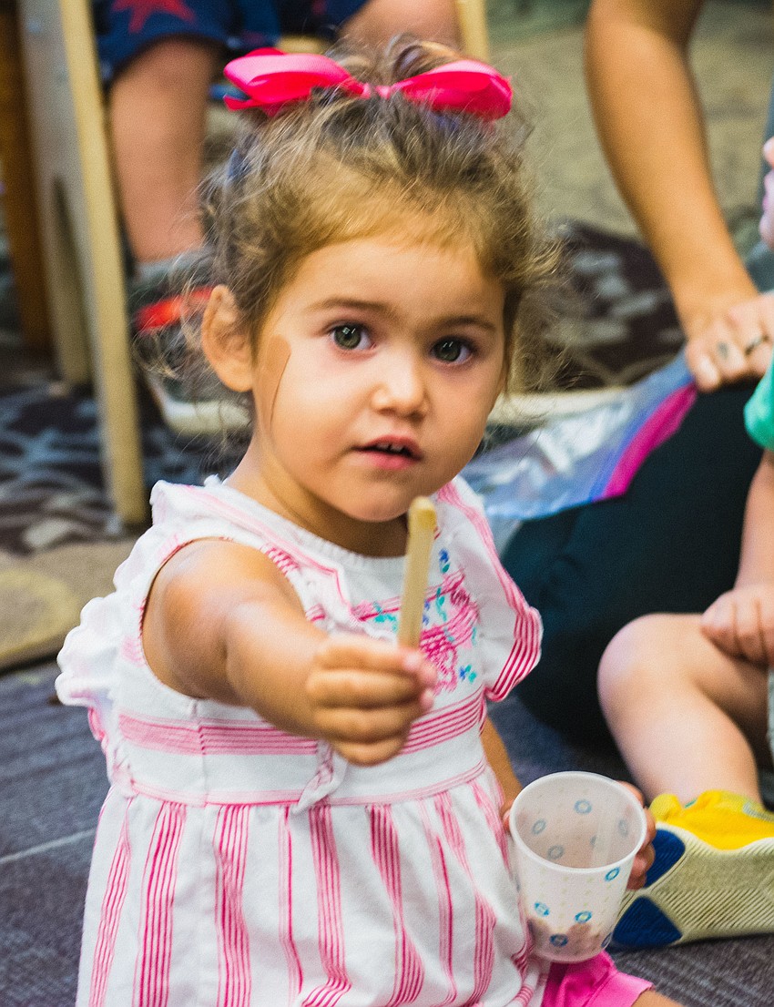 Anna Grace Balwin samples honey.