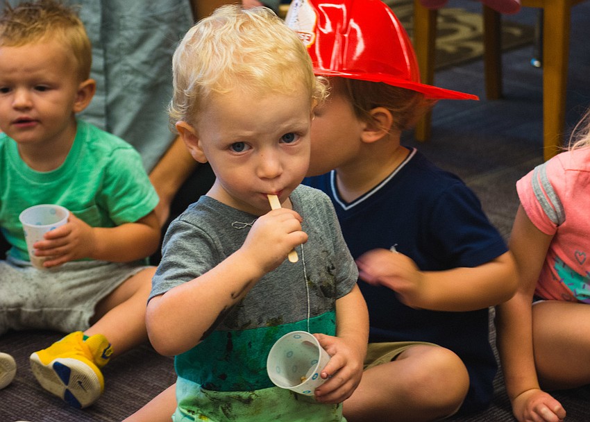 Asher Weber samples honey.