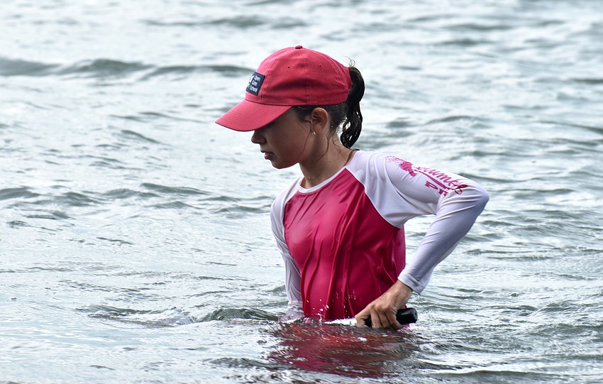 Anna Muranska dips her net in Sarasota Bay.