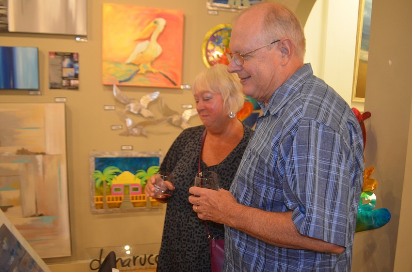 River Strand's Mike and Kathy Link enjoy the art at J&J Gallery.