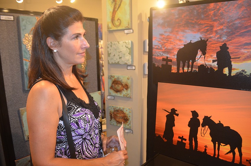 Greenbrook's Liz Klein says wine and art go well together as she enjoys the stop at the J&J Gallery.