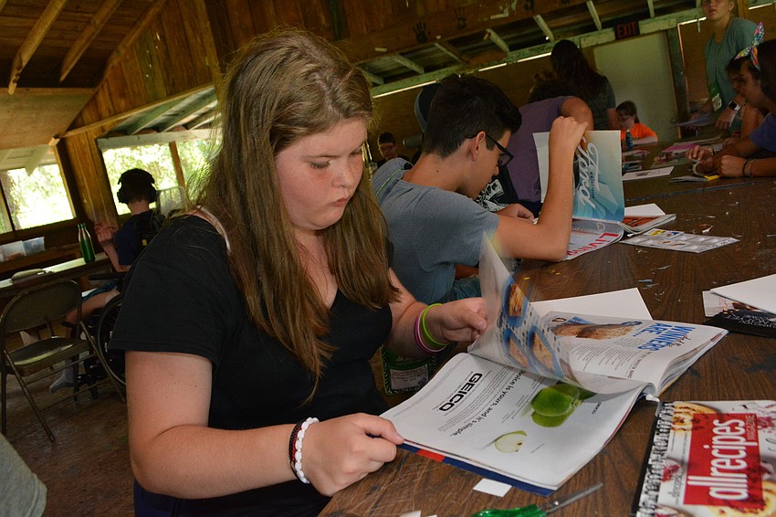Camper Rachel Manders, 15, pics out Ranch salad dressage picture from a magazine to use in her collage.