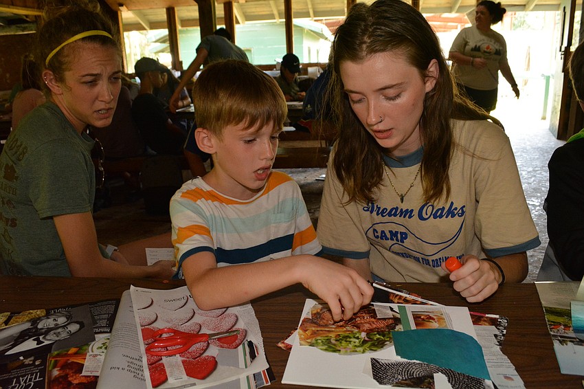 Jace Tabor gets help with his collage from counselor Samantha Barley. Counselor Jordan Whitley, left, watches.