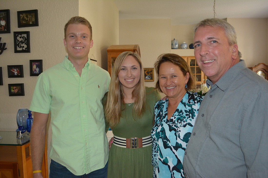 Trevor Lovett, Kirsten, Charlene and Bob Schmitt at the Schmitt&#39;s home in Summerfield. Photo by Jay Heater