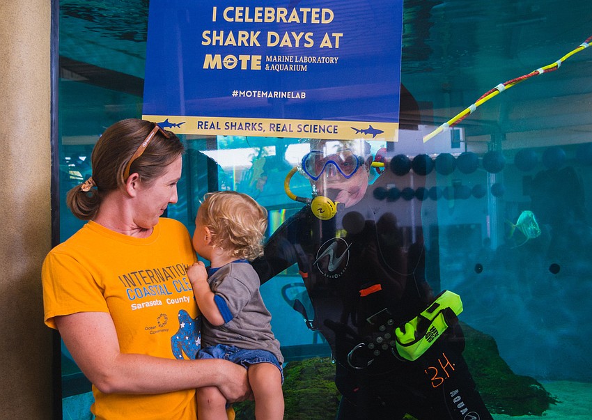 Leah Lapham and her daughter, Rowen, greet diver Ian Ramsbottom.