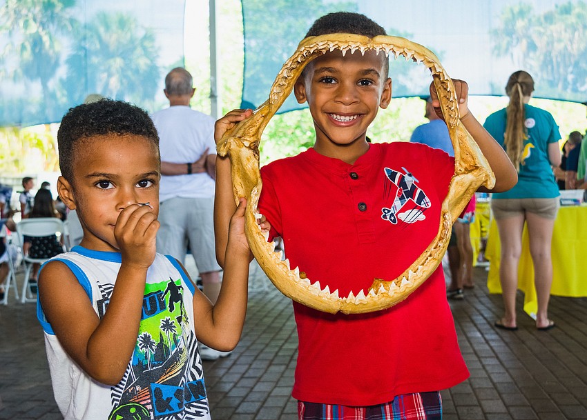 Derek and Spencer Simfukwe show off shark teeth.