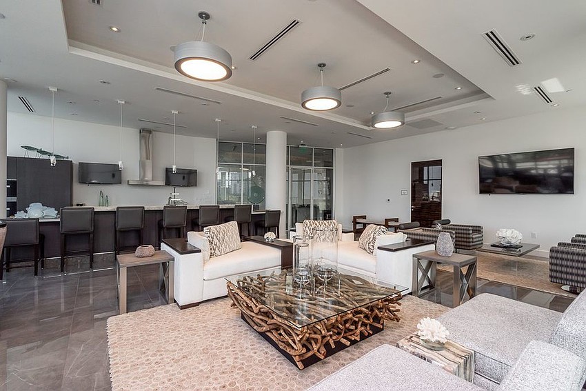 The Jewel features a lounge and bar common area in the condominium.