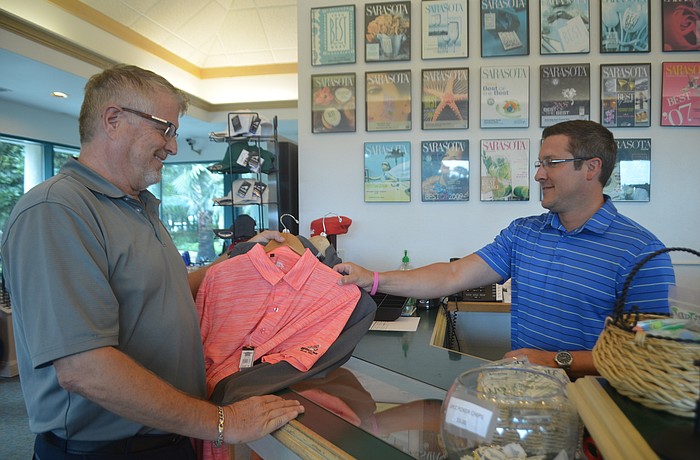 Lakewood Ranch's Ken Kaizen purchases shirts from employee of University Park Country Club Nick Gray.
