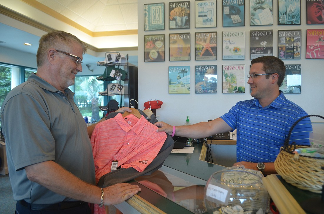 Lakewood Ranch&#39;s Ken Kaizen purchases shirts from employee of University Park Country Club Nick Gray.