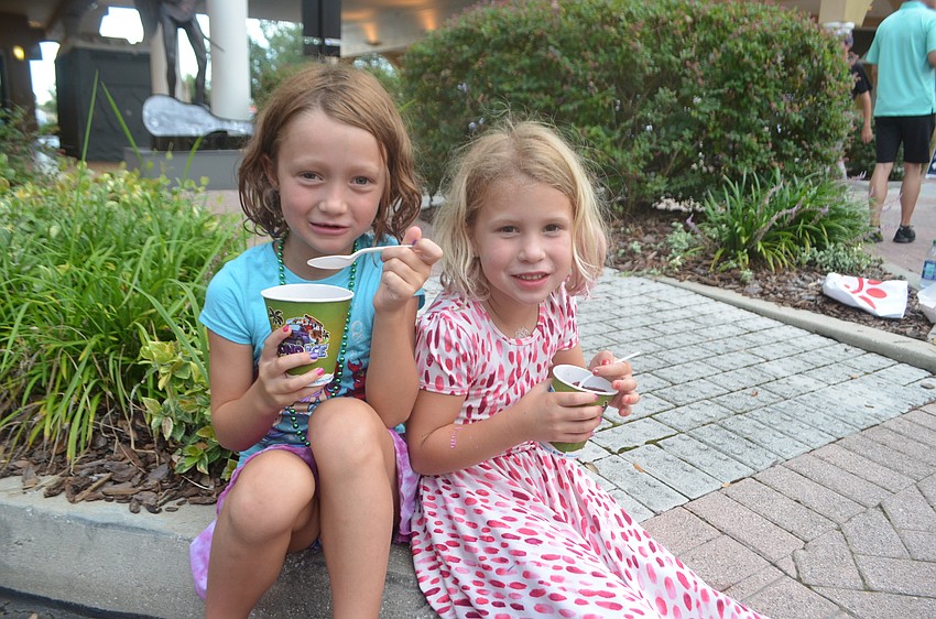 Sarasota's 6-year-old Sienna Tuttle and 5-year-old Briella Tuttle enjoy snow cones while trying to beat the heat.
