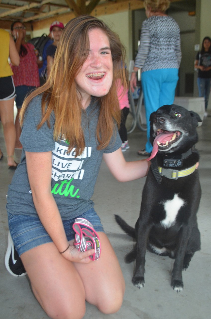 Parrish's Hannah Claxton with her dog Lucy, wait in line to grab a bite to eat.