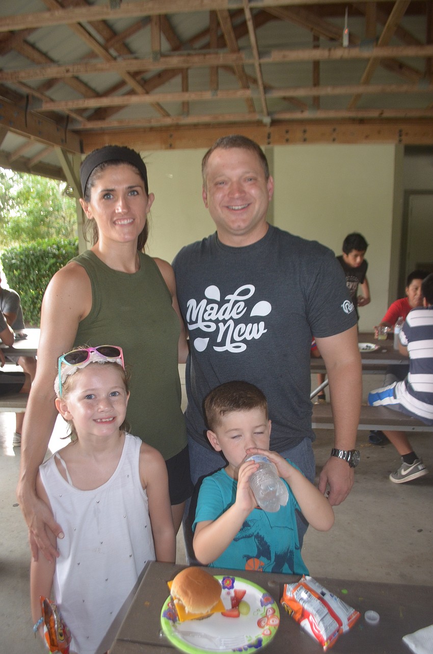 Greenbrook's Staci Hardinson, Brook Hardinson, 7, Pastor Rick Hardinson and their son Lincoln Hardinson, 4, try to cool off as the heat rises.