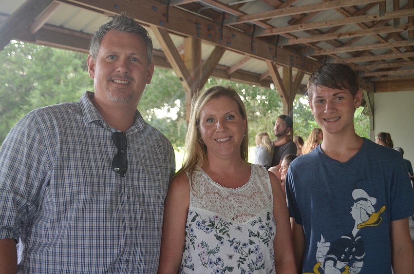 Summerfield's Mike Filewich, Melody Filewich and their son Tyler Filewich, 15, take a break from their picnic.