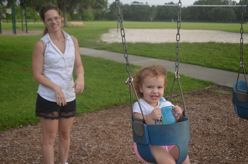Greenbrook's Janey Hair and Zoe Hair, 2, enjoy the swing set.