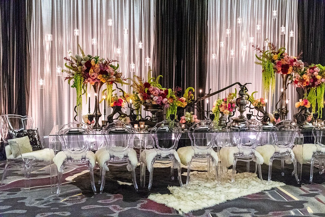 So Staged, along with wedding planner Choreographed Events, set up black and white furniture to make the colored florals pop. Courtesy of Dylan Jon Wade Cox Photography