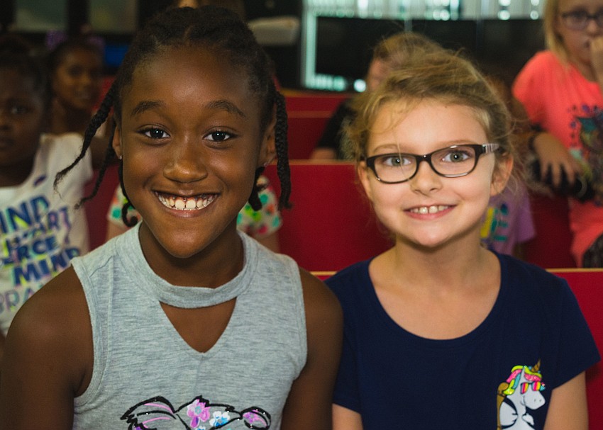 Girls Inc. members Brylie and Nichole  watch the play as audience members.