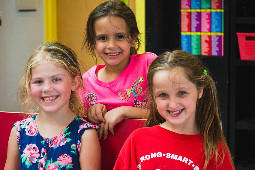 Girls Inc. members Olivia, Ashleigh and Charlotte wait to watch the play.