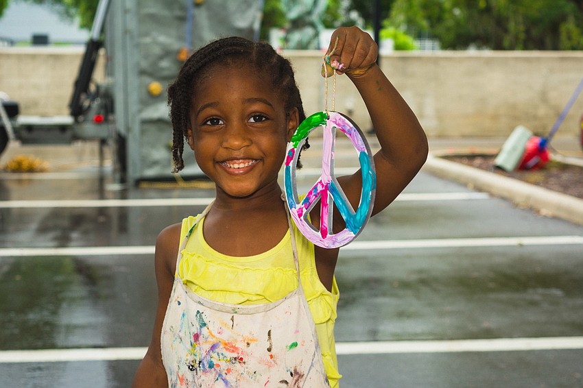 Karissa Williams shows off her painted peace sign.
