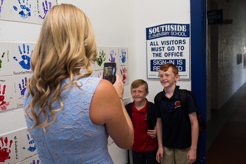 Tiffany Hamilton takes a photo of her boys, Cooper and Kennedy, at Southside Elementary.