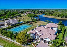 The home at 14111 11th Terrace N.E. features a private hedge with a tennis court and water access. It sold for $1,205,500.