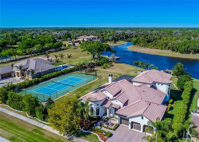 The home at 14111 11th Terrace N.E. features a private hedge with a tennis court and water access. It sold for $1,205,500.