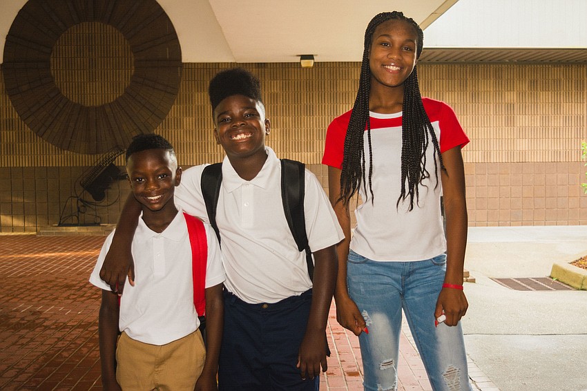 Emma E. Booker Elementary students Tayshawn Keno and Kevontay Hugan with their big sister, Tayanna Pack.