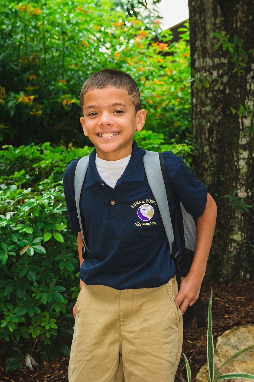 Emma E. Booker Elementary students A.J. Colon rocks his new uniform on the first day of school.