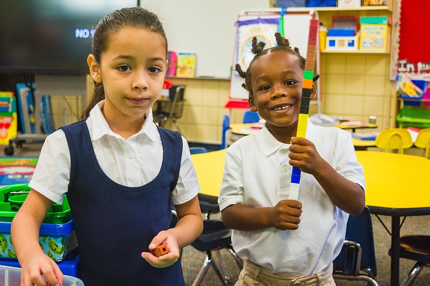 Emma E. Booker Elementary kindergartners Liz Kamila Molina and Torrance Timmons get to know  each other as classmates.