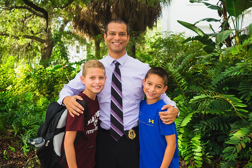 Gerardo Carillo drops his sons, Logan and Dylan, off at Bay Haven School of Basics Plus.