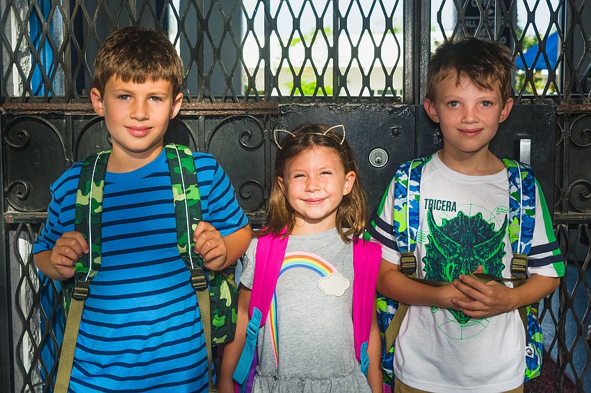 Siblings Toby, June and Justis Malone wait for the gate to open at Bay Haven School of Basics Plus.