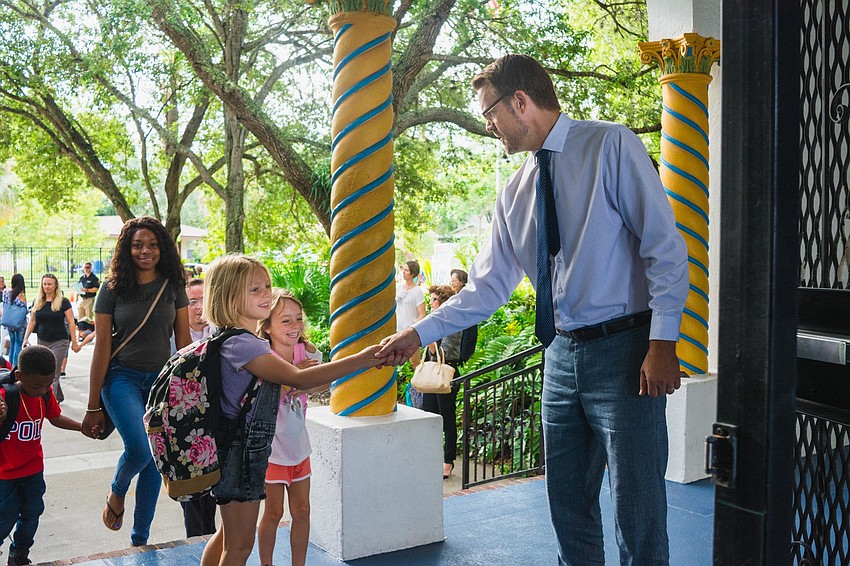 Bay Haven School of Basics Plus principal Chad Erickson greets Piper and Sofie Francher.