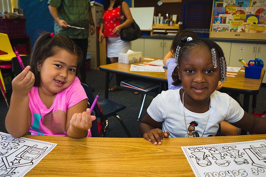 Bay Haven School of Basics Plus kindergartners Alyssa Scavelli and Jachai Devecaux get ready for class.