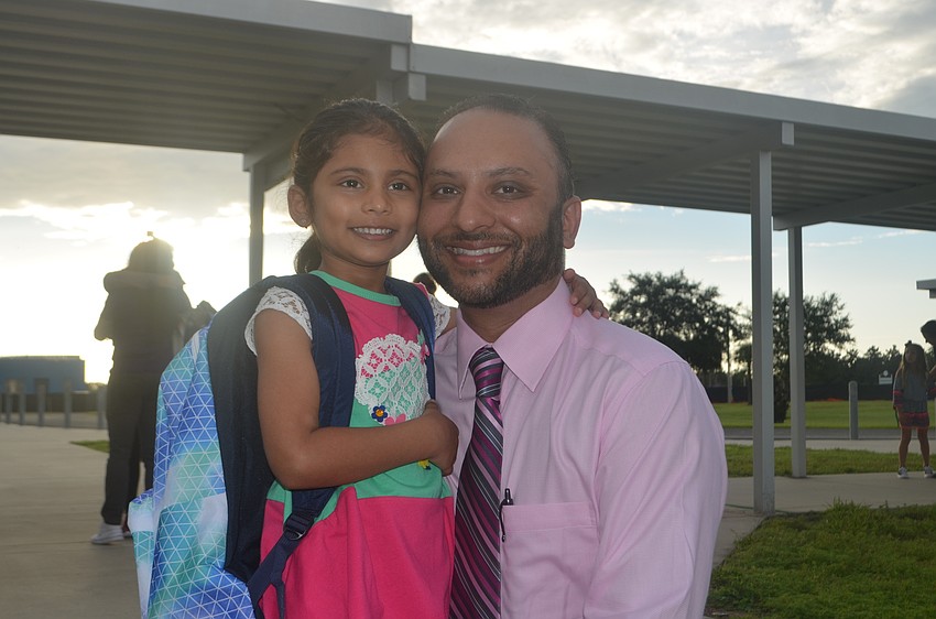 Kindergartner Aarya Parbhoo, 5, and her father Pritesh Parbhoo are feeling excited about kindergarten, especially the opportunity to get to play on the monkey bars.