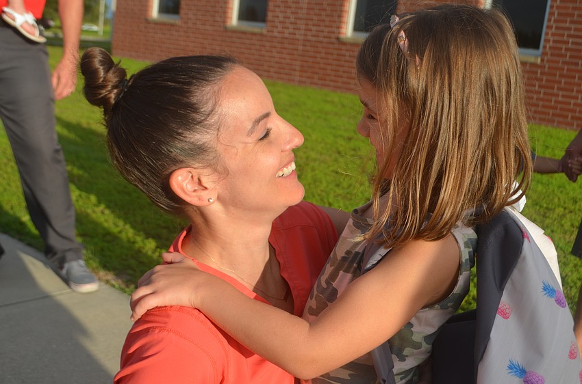 Lindsay Ogden gives her kindergartner, Emmy Ogden, 5, a pep talk before she walks inside.