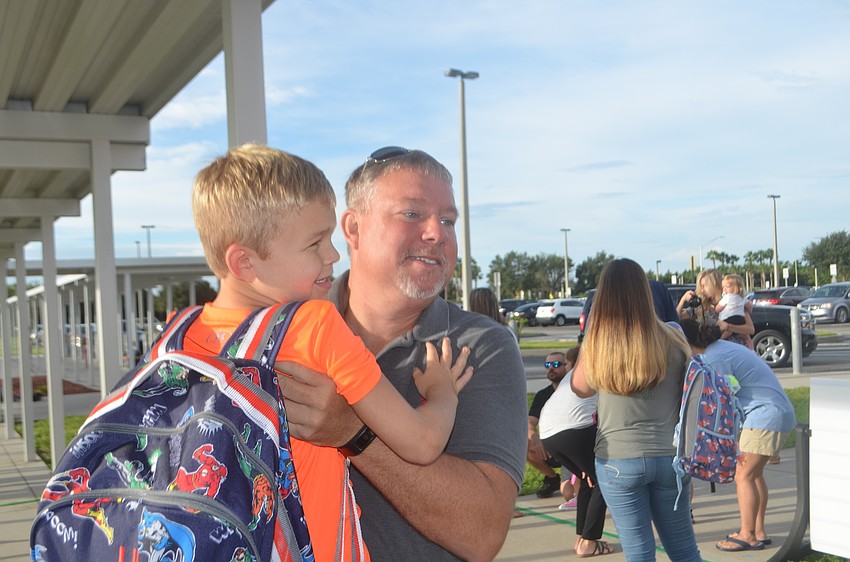 Anthony Veerkamp hugs his son Luke Veerkamp, 5, but says that he's excited for him.