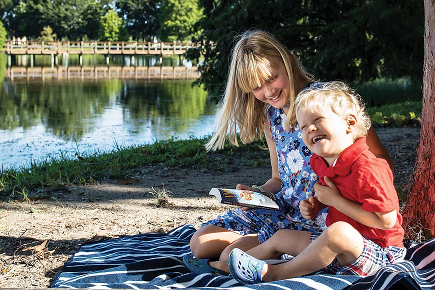 Sara Martin, 10, and brother Ryan, 3, spend a lot of time exploring parks, especially Heritage Harbour Park, where Sara likes to read under the trees.