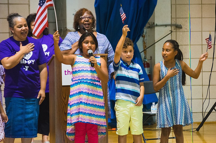 HIPPY alums lead the Pledge of Allegiance.