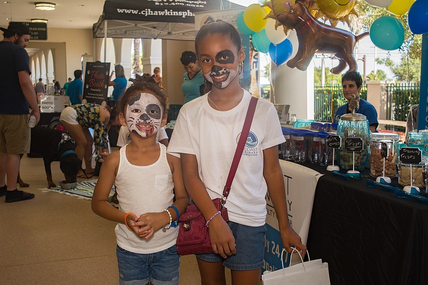 Honie and Marlee Furlow give away doggie goodie bags from Suncoast Veterinary.
