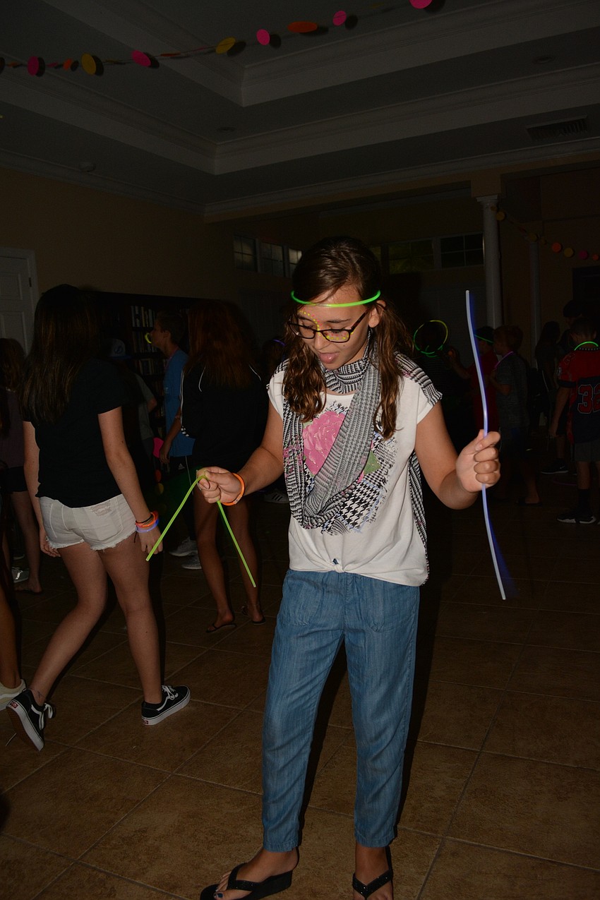 Zoey Putter twirls glow sticks on the dance floor.