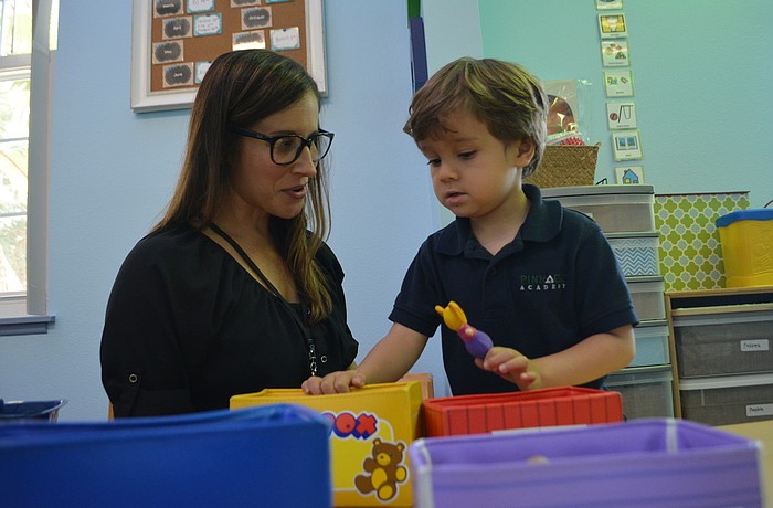 Teacher and behavioral therapist Courtney Rune works with Adam Schwab at Pinnacle Academy in Lakewood Ranch.