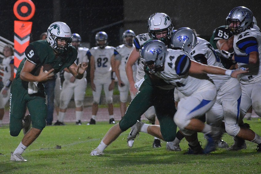 Senior Lakewood Ranch quarterback George Davis (9) sprints ahead for a 25-yard touchdown.