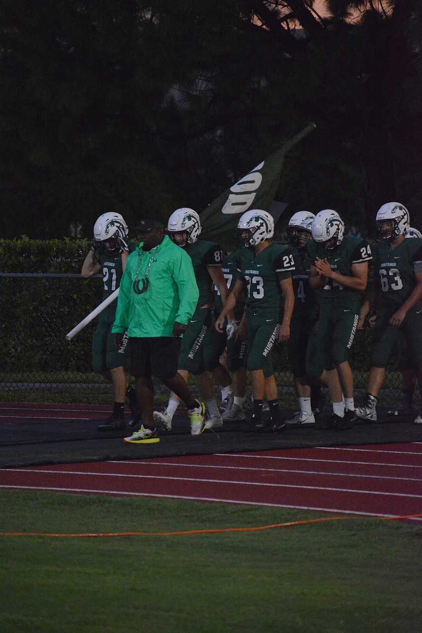 The Mustangs take the field pregame.