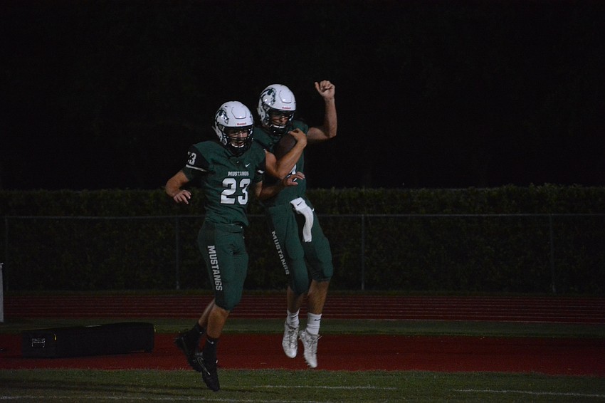 Senior wideout Kieran Connolly and senior quarterback George Davis celebrate after Davis' touchdown.