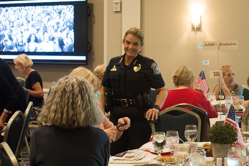 Keynote speaker and Sarasota chief of police Bernadette DiPino greets attendees.