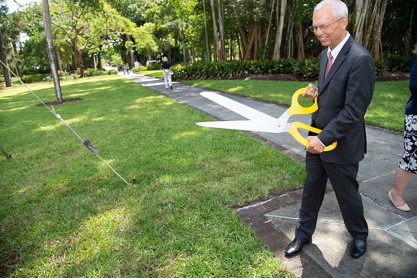 Executive Director Steven High holds scissors for the ribbon cutting.  Photo by Daniel Perales.
