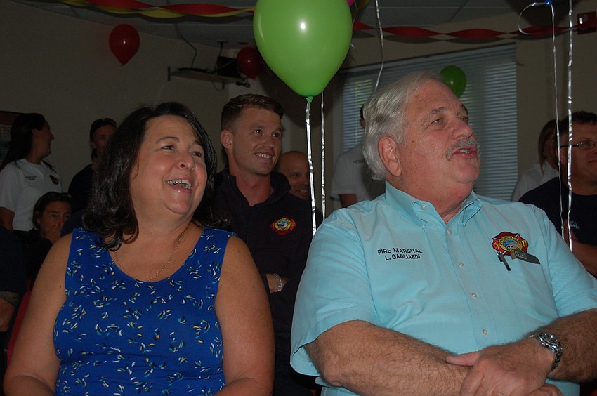 Gail and Lou Gagliardi laugh at a multi-media presentation, set to the music of George Thorogood's Bad to the Bone.