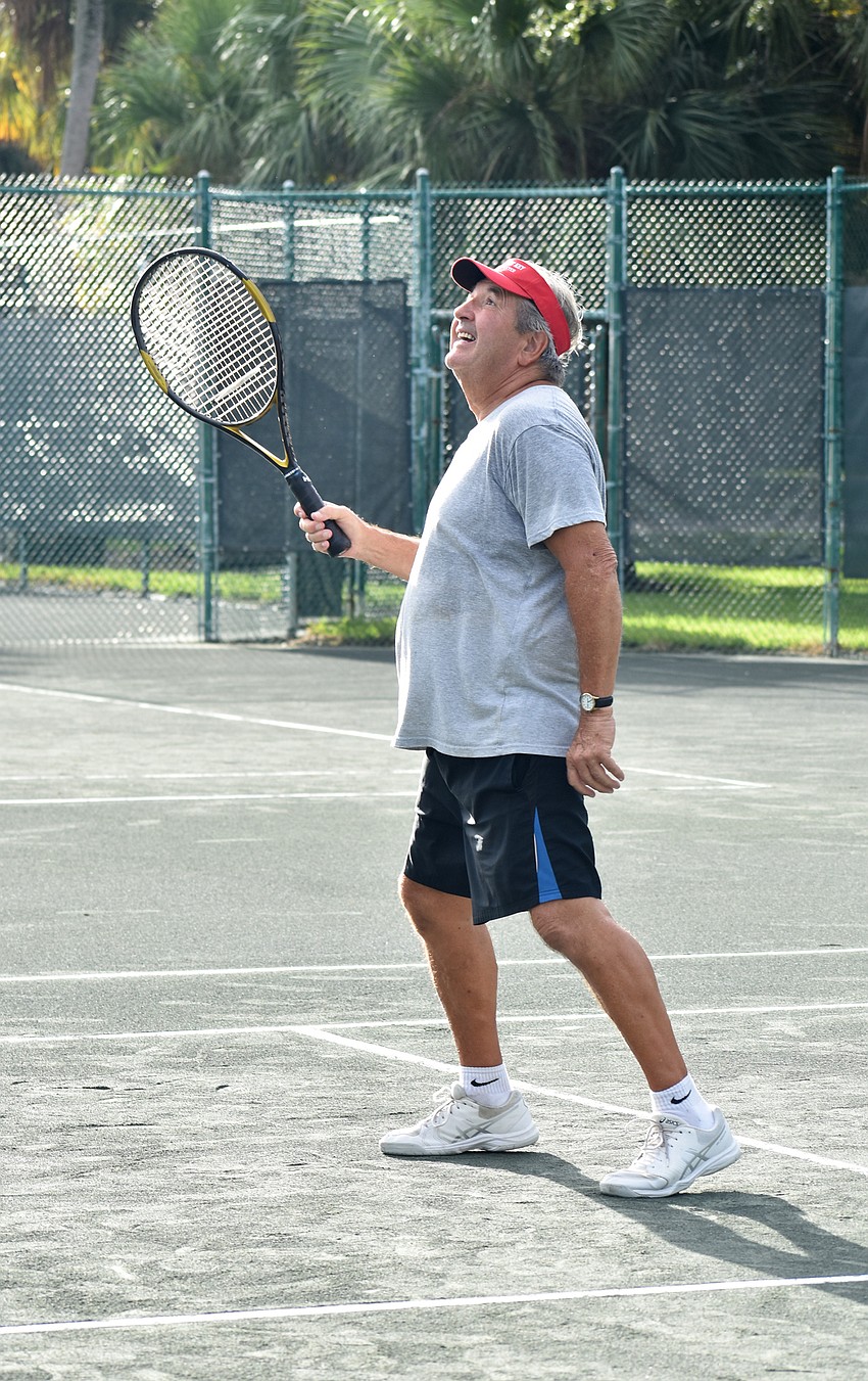 Bob Winters watches the ball fly to his side of the net after an opponent serves it.