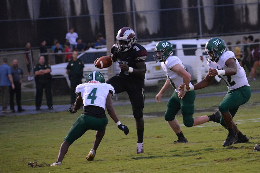 Sophomore running back Michael Hayes jumps to hurdle a defender.