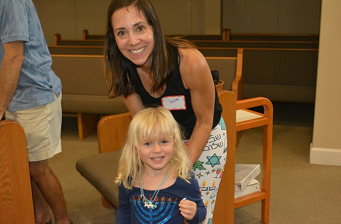Lake Club's Susan Beck volunteers at the Tot Shabbat program with her daughter, Josie, as they prepare for High Holy Days.