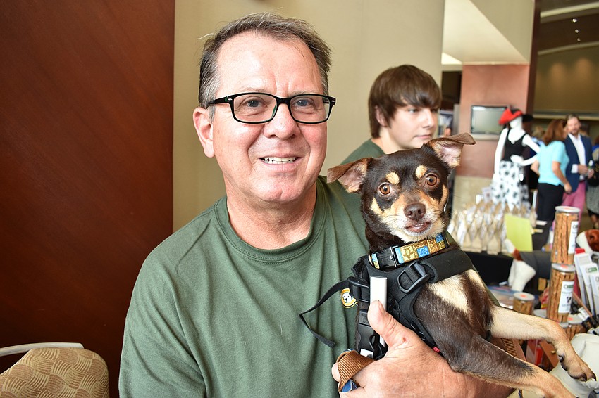 Mark Shambour, a canine good citizen evaluator at K9 Korral, adopted Spencer and now does swimming and laser therapy with him to help him gain some movement in his legs.